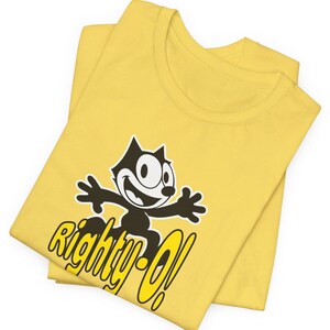 May include: Yellow t-shirt with a black and white cartoon cat wearing a surprised expression. The cat is holding its arms out and the text "Righty-O!" is printed below the cat.