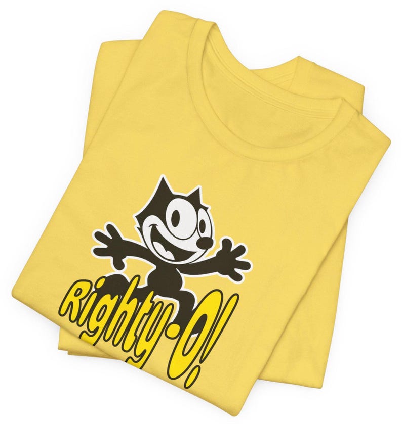 May include: Yellow t-shirt with a black and white cartoon cat wearing a surprised expression. The cat is holding its arms out and the text "Righty-O!" is printed below the cat.
