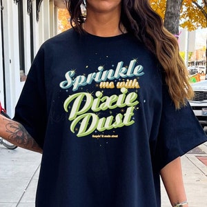 May include: Black oversized t-shirt with a green and yellow graphic that says "Sprinkle me with Dixie Dust".