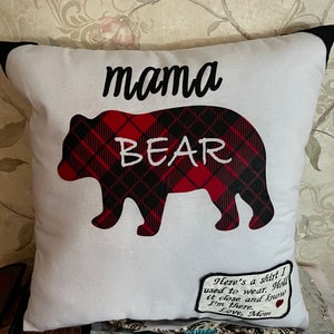 May include: White pillow with a black and red plaid bear silhouette and the text "mama bear". A small tag attached to the pillow reads "Here's a shirt I used to wear. Hold it close and know I'm there. Love, Mom."