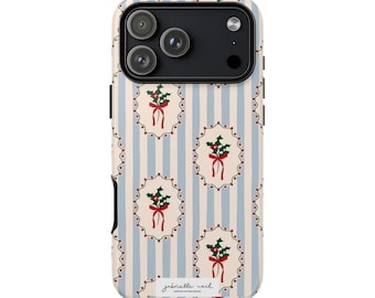 May include: A phone case with a festive design. The case features a pattern of light blue vertical stripes and repeating oval motifs with holly and red bows. The text "gabrielle neil" is printed at the bottom.