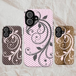 May include: Three phone cases with floral designs. One case is brown with white polka dots and a white floral pattern. Another is pink with black polka dots and a grey floral design. The third case is brown with a white floral pattern.