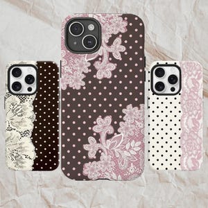 May include: Three phone cases with floral lace and polka dot designs. The cases feature a mix of colors, including brown, white, and pink. The cases are designed to fit a smartphone.