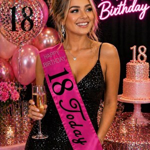 May include: A woman wearing a black sequined dress and a pink sash that says "18 Today" and "Happy Birthday". She is holding a glass of champagne. Pink balloons and a cake with an "18" are in the background. A neon sign says "Happy Birthday".