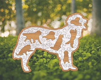 May include: A wooden jigsaw puzzle shaped like a dog. The puzzle is made up of smaller pieces that fit together to form the shape of a dog. The puzzle is a light brown color and has a white background.