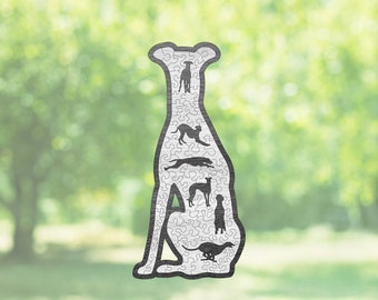 May include: A wooden puzzle in the shape of a greyhound dog. The puzzle is made up of smaller pieces that fit together to form the shape of the dog. The dog is sitting down with its legs tucked under its body. The puzzle is a fun and challenging way to test your skills.