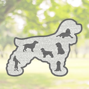 May include: A wooden jigsaw puzzle shaped like a Cocker Spaniel dog. The puzzle is made up of many small pieces and features a silhouette of a Cocker Spaniel dog in the center.