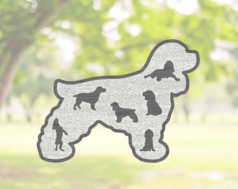 May include: A wooden jigsaw puzzle shaped like a Cocker Spaniel dog. The puzzle is made up of many small pieces and features a silhouette of a Cocker Spaniel dog in the center.