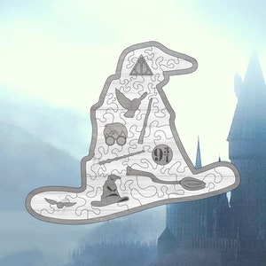 May include: A wooden jigsaw puzzle shaped like the Sorting Hat from the Harry Potter series. The puzzle features various Harry Potter symbols, including the Hogwarts crest, a wand, a broom, and the number "9 3/4".