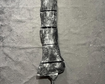May include: A long, segmented silver-colored prop sword with a textured, weathered surface finish. The blade is divided into five distinct sections, featuring a narrow handle at the base and a wider, flared tip at the top, accompanied by small loose parts.