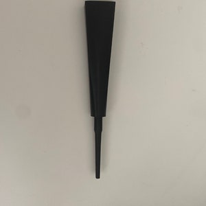 May include: A black metal garden stake with a pointed tip and a wide, flat top.