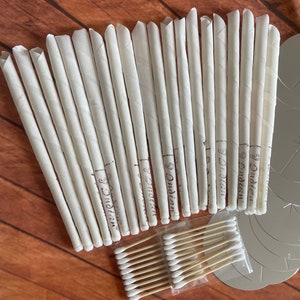 May include: A set of 20 white ear candles with the text "Dr. Didian" printed on each candle. The set also includes a package of 20 cotton swabs.