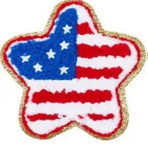 May include: A star-shaped patch featuring the American flag design. The patch has a gold glitter border, a blue field with white stars, and red and white stripes, representing the United States of America.
