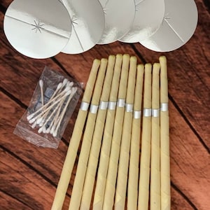 May include: A set of ear candles, also known as  ear candling cones, for earwax removal. The set includes 12 ear candles, 5 silver-colored ear candle holders, and a package of cotton swabs.