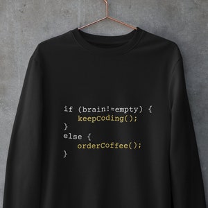 May include: Black sweatshirt with white text that reads "if (brain!=empty) { keepCoding(); } else { orderCoffee(); }"