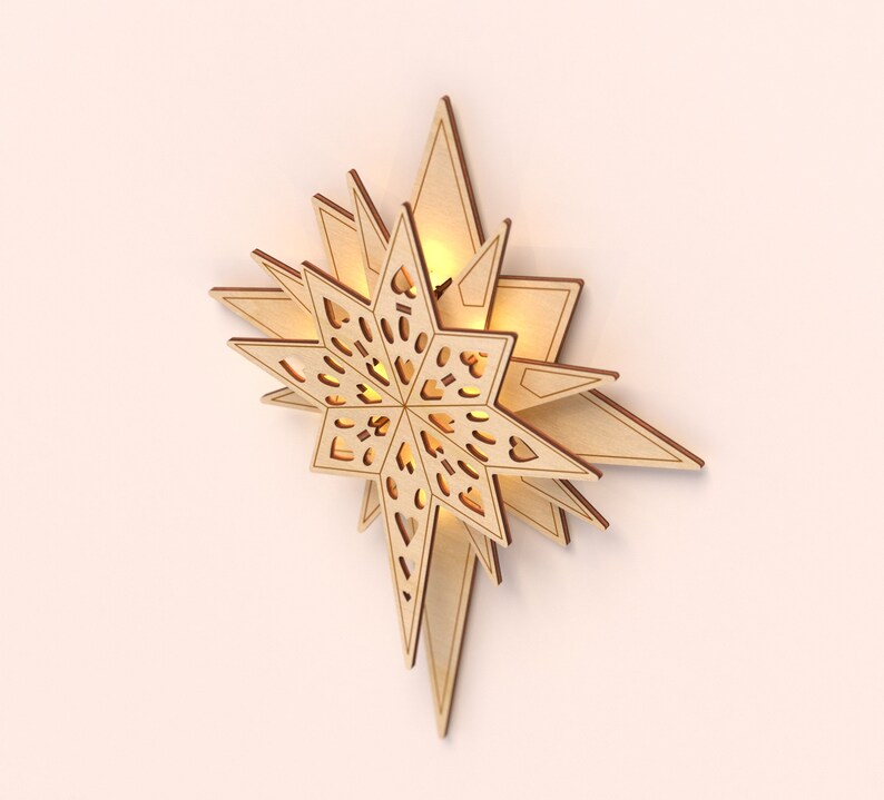 May include: A wooden star-shaped wall decor with a cut-out design and a warm glow emanating from the center.