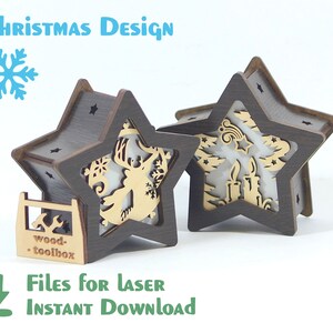 May include: Two wooden star-shaped Christmas light boxes with laser cut designs. One box features a reindeer and the other features a candle and a tree. The text "wood-toolbox" is printed on the bottom of the box.