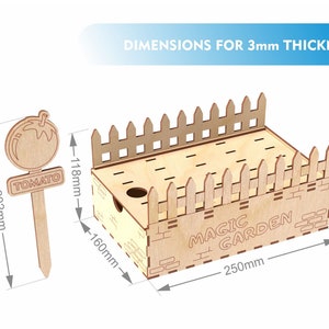 May include: A wooden Magic Garden planter box with a picket fence design, a tomato plant marker, and dimensions for 3mm thickness. The planter box is 250mm long, 160mm high, and 118mm wide. The tomato marker is 202mm tall.