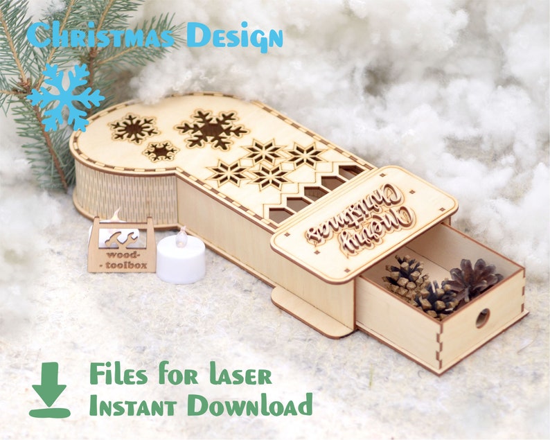 May include: A wooden Christmas stocking box with a drawer that slides out. The box is decorated with snowflakes and the words "Merry Christmas".
