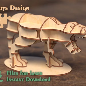 Puede incluir: Un modelo de dinosaurio T-Rex de madera con estantes, diseñado para corte por láser. El modelo está ensamblado y listo para ser utilizado como una unidad de estantería. La imagen incluye el texto "Toys Design" y "Archivos para láser DESCARGA INSTANTÁNEA".