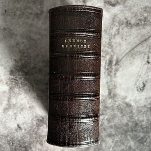May include: A brown leather-bound book with the title "Church Services" embossed in gold lettering.