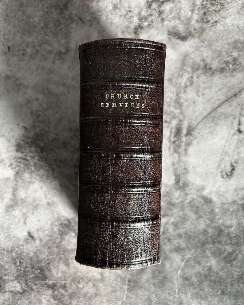 May include: A brown leather-bound book with the title "Church Services" embossed in gold lettering.