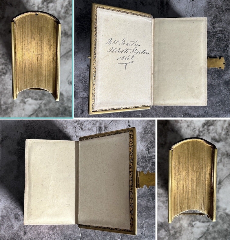 May include: A gold-colored photo album with a hinged clasp. The album is open to reveal a blank page with handwritten text: "Miss J. Austin, Abbotsleigh, Hiffton, 1862."