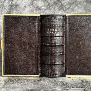 May include: A brown leather-bound book with gold accents and the title "CHURCH SERVICES" embossed on the spine.