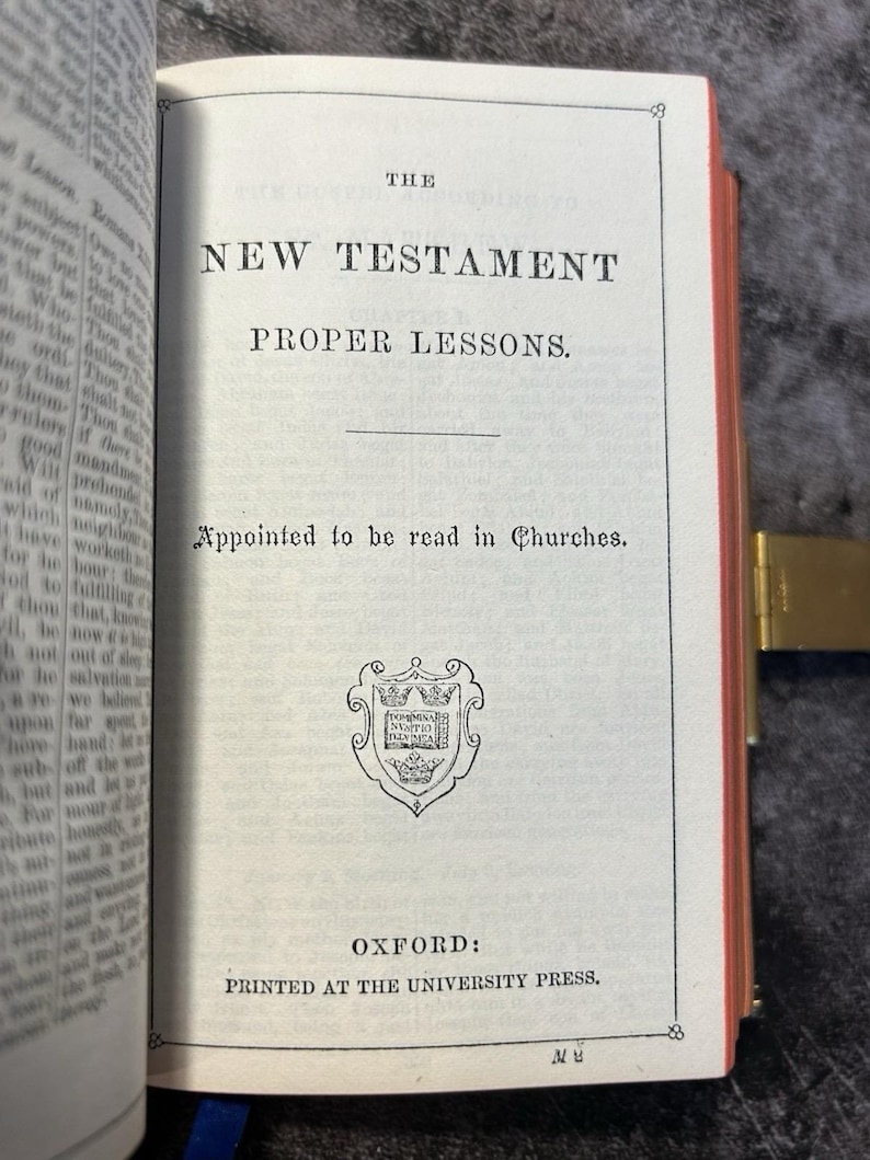 May include: Open book displaying the title "THE NEW TESTAMENT PROPER LESSONS." The text "Appointed to be read in Churches" is below the title. The book is printed by Oxford University Press.