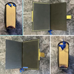 May include: A black journal with gold-edged pages and a gold clasp. The cover has a gold border. A blue ribbon bookmark is attached. The journal is shown closed, open, and from the side.