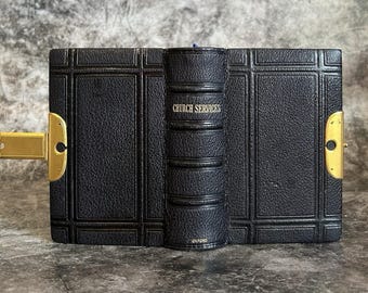 May include: A vintage black leather-bound book with gold accents and a clasp. The spine reads "CHURCH SERVICES" in gold lettering. The book is from Oxford.