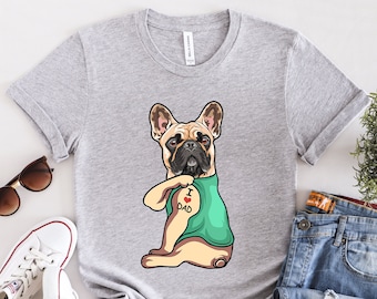 May include: Gray t-shirt with a cartoon image of a French bulldog with a tattoo that says "I love Dad" on its arm.