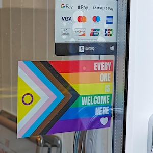 May include: A sticker displaying the Progress Pride flag and the message "EVERY ONE IS WELCOME HERE". The flag combines rainbow stripes with additional colors and symbols. Payment methods are shown above.