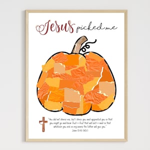 May include: A framed print featuring a large orange pumpkin made of torn paper pieces. The words "Jesus picked me" are written above the pumpkin in a cursive font. A cross and Bible verse are at the bottom.