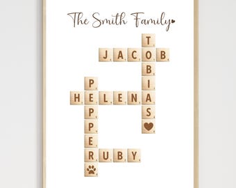 May include: A framed print featuring a family name crossword puzzle. The words "The Smith Family" are at the top. The crossword includes names like Jacob, Helena, and Ruby, with a paw print and heart symbol.
