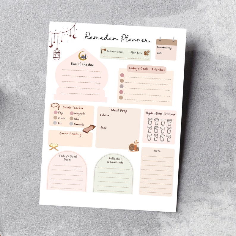 May include: A printable Ramadan planner with sections for daily goals, meal prep, hydration tracking, Quran reading, and reflection. The planner features a light pink and brown color scheme with illustrations of crescent moons, stars, and a mosque.