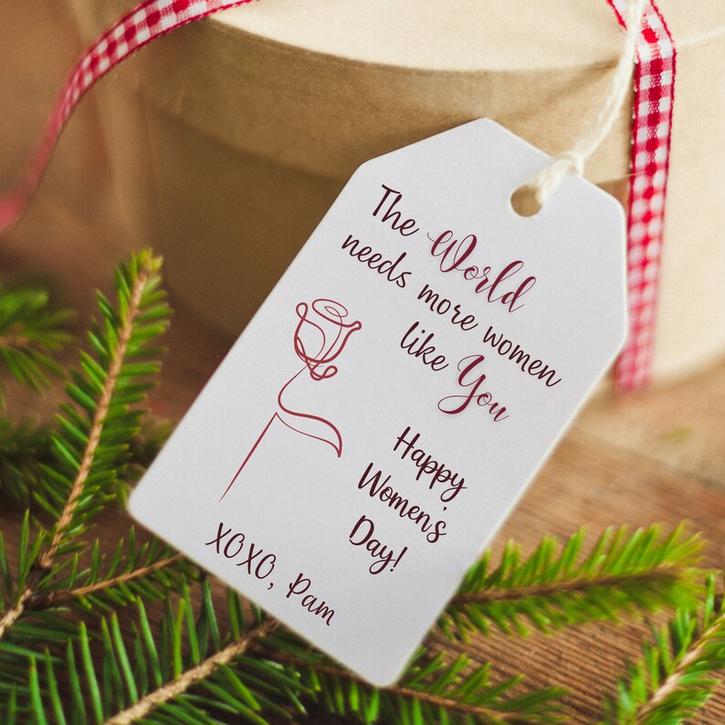 May include: White gift tag with a red rose illustration and the text "The World needs more women like You Happy Women's Day! XOXO, Pam"