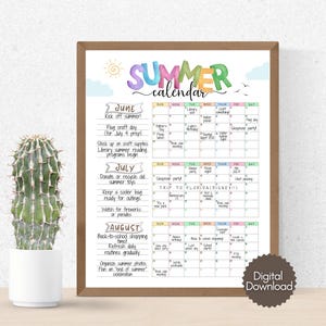 May include: A framed summer calendar with a watercolor design. The calendar includes the months of June, July, and August, with colorful text and illustrations. The calendar is displayed next to a cactus in a white pot.