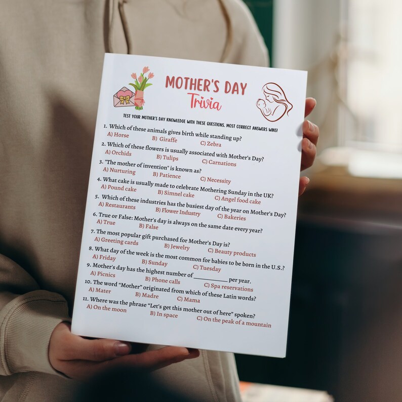 May include: A Mother's Day trivia game with questions about animals, flowers, and traditions. The game is printed on a white card with a colorful floral design and a cartoon image of a mother and child.