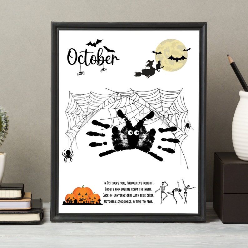 May include: A black framed print with a white background. The print features a black spider made with handprints, a spider web, a witch flying on a broomstick, a full moon, and a few bats. The text on the print reads 'October' and 'In October's veil, Halloween's delight, Ghosts and goblins roam the night. Jack-o-lanterns grin with eerie cheer, October's spookiness, a time to fear.'