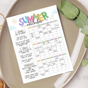 May include: A colorful summer calendar with the word "SUMMER" in large, playful letters. The calendar includes dates for June, July, and August, with summer-themed activities like "Flag craft day" and "Back-to-school shopping".