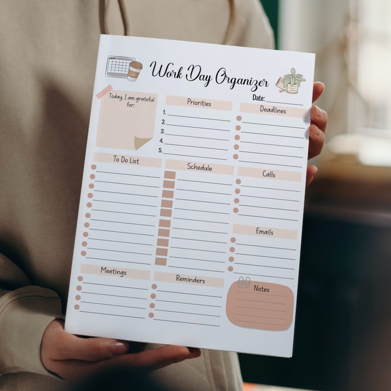 May include: A white printable work day organiser with a brown and white coffee cup, a calendar, and a potted plant illustration. The organiser has sections for priorities, deadlines, to do list, schedule, calls, emails, meetings, reminders, and notes.