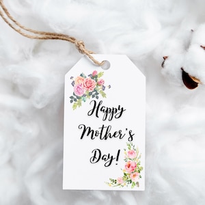 May include: White gift tag with the text "Happy Mother's Day!" in black script font. The tag is decorated with pink and white watercolor flowers.