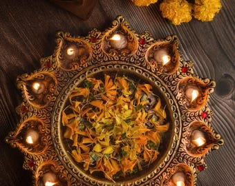 The 11 diya thali is a stunning decorative piece, perfect for festivals and rituals ,it makes a thoughtful gift radiating warmth decor.
