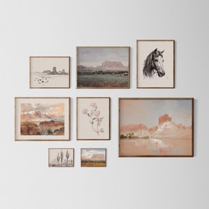 May include: A collection of eight framed prints featuring various landscapes and nature scenes. The prints are arranged in a grid pattern on a white wall. The prints include a desert landscape, a horse's head, a floral arrangement, and a cactus.
