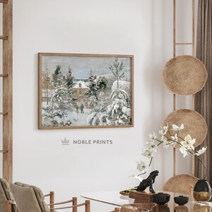 May include: A framed winter landscape painting with snow-covered trees and buildings. The artwork features a muted color palette of grays, whites, and browns, creating a serene and vintage aesthetic. The text "NOBLE PRINTS" is at the bottom.