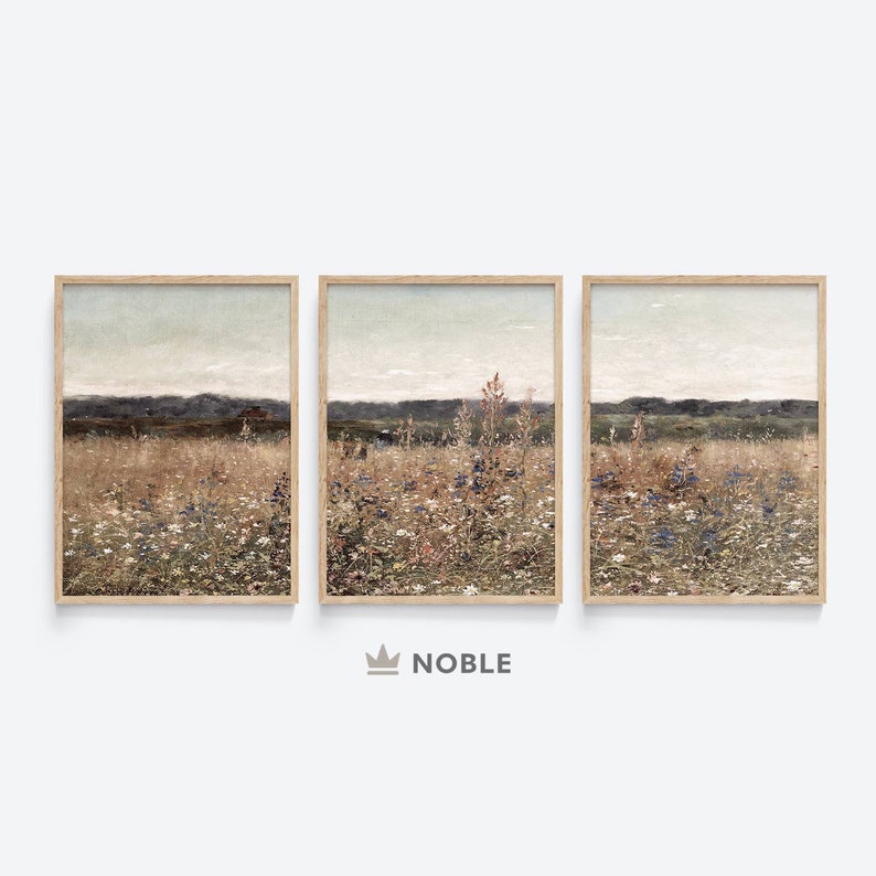 May include: A set of three framed landscape paintings depicting a field of wildflowers with a distant mountain range in the background. The paintings are in a muted color palette of browns, greens, and blues.