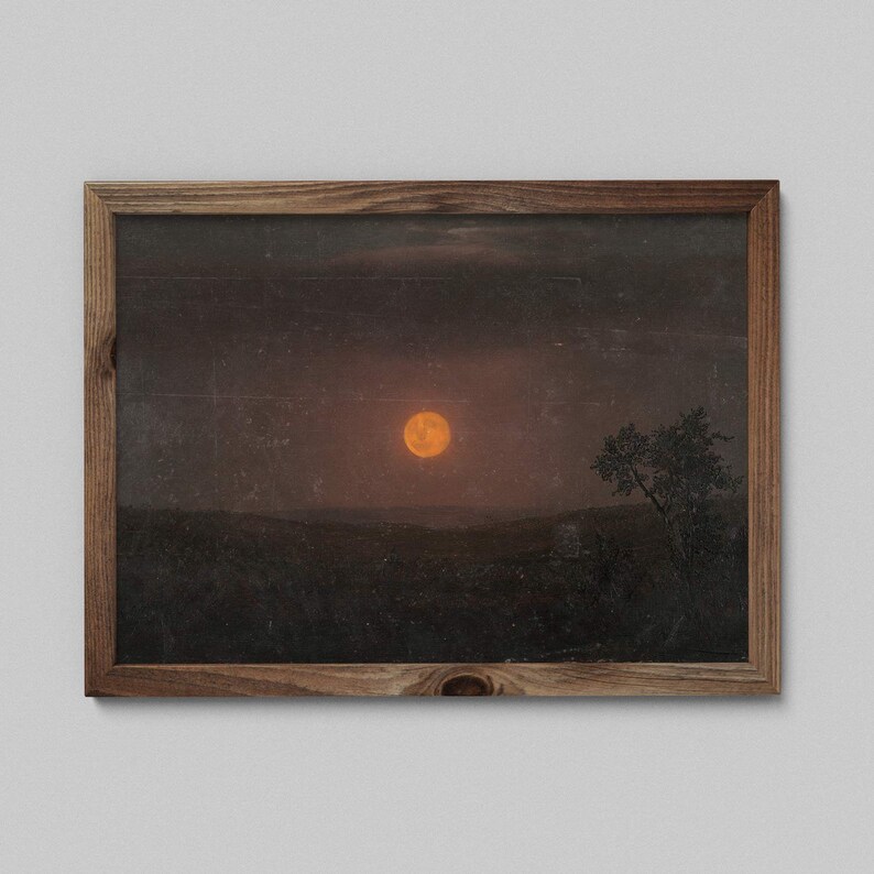 May include: A framed print of a landscape with a large orange moon in the sky. The moon is surrounded by a dark, cloudy sky. A single tree stands in the foreground, silhouetted against the moon.