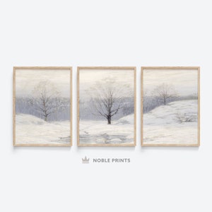 May include: A set of three framed prints depicting a winter landscape with bare trees and a snowy field. The prints are in a light wood frame and have a muted colour palette.