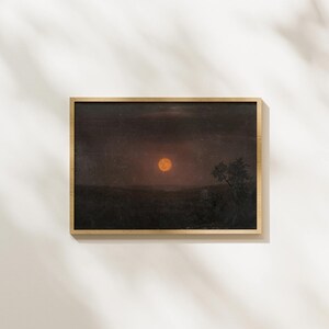 May include: A framed painting of a dark landscape with a large, orange moon in the sky. A single tree stands silhouetted against the moon.